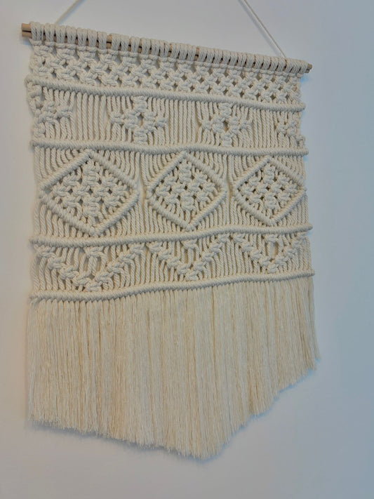Small macrame wall hanging in v-shape